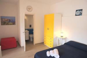 a bedroom with a bed and a yellow cabinet at Villa Manzoni in Campese