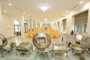 a large room with chairs and tables and a salon at MOMALI Hotel Ninh Binh in Ninh Binh