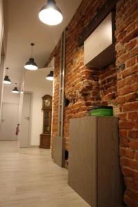 a room with a brick wall and a wooden floor at Mieszkanie Wilcza in Warsaw