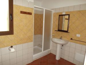 a bathroom with a sink and a shower at Yellon House in Santa Maria Navarrese