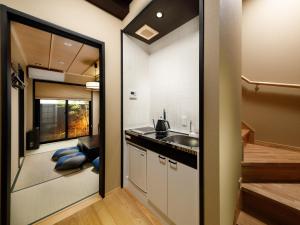 a small kitchen with a sink and a counter at Kanade Fushimiinari-Taishame in Kyoto
