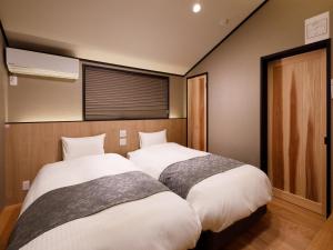 מיטה או מיטות בחדר ב-Kanade Fushimiinari-Taishame