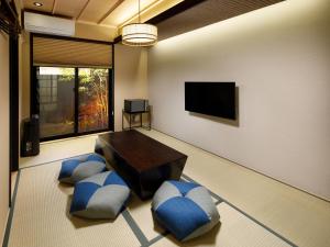 a living room with a table and blue chairs at Kanade Fushimiinari-Taishame in Kyoto
