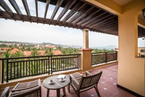 a balcony with a table and chairs and a view at Pandanus Resort in Mui Ne