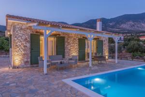 a villa with a swimming pool and a house at Grapevine Cottage in Argostoli