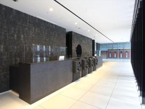 a lobby with a row of washers and dryers at Hakata Green Hotel No.1 in Fukuoka