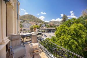 a balcony with chairs and a view of a city at Liberty House (by Vacation Service) in Cefalù