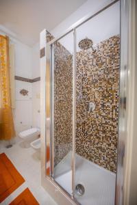 a shower with a glass door in a bathroom at Liberty House (by Vacation Service) in Cefalù +11 photos