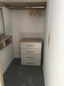 a walk in closet with a dresser and a shelf at St Andrew's Retreat in Tydd Saint Giles