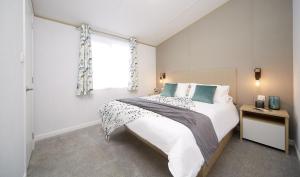 a bedroom with a large bed and a window at St Andrew's Retreat in Tydd Saint Giles