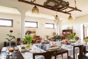 a dining room with a table with food on it at Bed & Breakfast Corte Zen in Adria