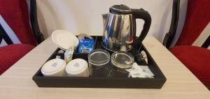 a tray with a coffee pot on top of a table at COSY CHAMBRE in Pondicherry