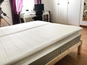 a mattress on a bed frame in a room at The Cozy Little House in Motala