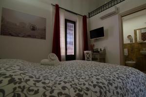 a bedroom with a large bed with a stuffed animal on it at A Due Passi in Grammichele