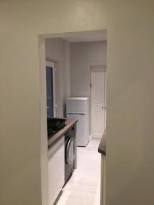 a kitchen with a washer and dryer in a room at Beach cottage in Gorleston-on-Sea