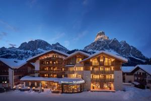 a lodge with a mountain in the background at Hotel Marmolada in Corvara in Badia