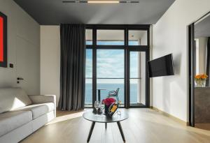 a living room with a couch and a table at ONLY Boutique Suites & Residences in Limassol