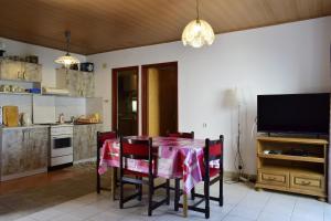a kitchen with a table with a pink table cloth at Apartment Tommy in Malinska