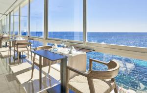 a restaurant with a view of the ocean at Globales Cala Viñas Adults Only 16+ in Cala Vinyes