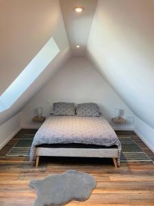 ein Schlafzimmer mit einem Bett im Dachgeschoss in der Unterkunft Le Courlis in Guimaëc
