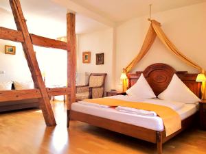 a bedroom with a large bed with a wooden frame at Hotel Rathausglöckel in Baden-Baden