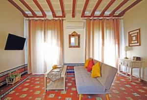 a living room with a couch and a tv at Palace-House Hércules 92 in Seville