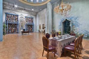 a dining room with a table and chairs and a chandelier at Wyndham Garden Haikou South in Haikou