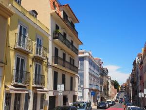 a city street with cars parked on the street at Bela Vista - Lissabon Altstadt in Lisbon