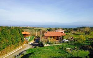 a house on a hill with a road next to it at Casa Las Vistas Llanes in Nueva de Llanes