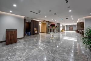 a lobby of a hotel with a marble floor at ABAR HOTEL APARTMENTS DIP-1 in Dubai