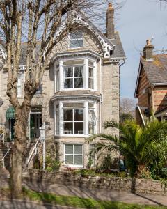 a large brick house with a large window at The Pendennis Guest House in Penzance