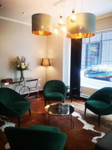 
a living room filled with furniture and a large window at First Hotel Millennium in Oslo
