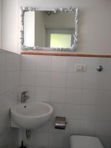 a bathroom with a sink and a mirror at Soleluna in Capri
