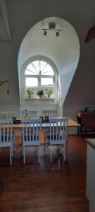 a dining room with a table and chairs and a window at Gällared 710 - Bed & Kitchen in Ullared