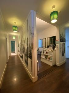 a hallway with pictures on the walls of a building at Green Heart Hostel in Lisbon