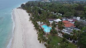 
a beach with palm trees and palm trees at Jacaranda Indian Ocean Beach Resort in Diani Beach
