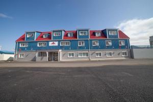 a large building with blue and red roofs at Kirkjufell Hotel by Snæfellsnes Peninsula West Iceland - Grundarfjordur in Grundarfjordur