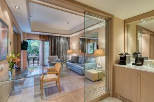 a living room with a blue couch and a chair at Rodos Park in Rhodes Town