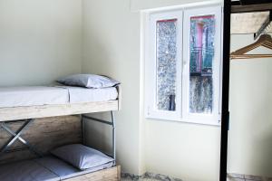 a room with two bunk beds and a window at Girastrittue Colobraro in Colobraro