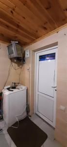 a room with a door with a television and a desk at Дом с удобствами in Cherkasy