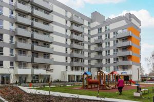 an apartment building with a playground in front of it at Business Apartments Warsaw Mokotów in Warsaw