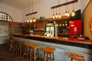 a bar with a row of wooden stools at Prospectors Inn in Lüderitz