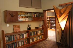 a room with book shelves filled with books at Prospectors Inn in Lüderitz