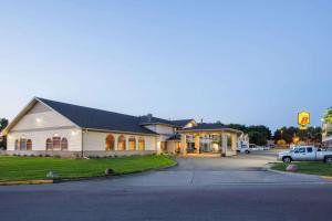 a building with a car parked in front of it at Super 8 by Wyndham Brookings in Brookings