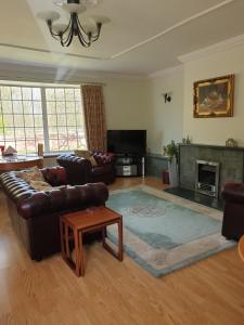 
a living room filled with furniture and a fire place at York Rose B&B in York

