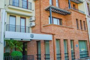 a brick building with a sign on the side of it at Hotel Voyager in Tbilisi City