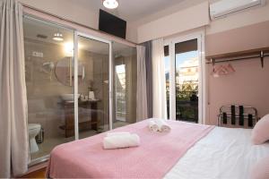 a bedroom with a bed with two towels on it at Kalamata Art Rooms in Kalamata