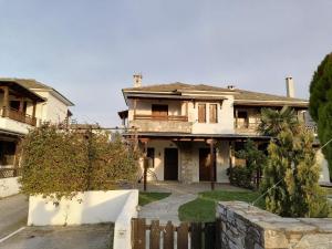 an old house with a fence in front of it at Harmony seaside apartments in Koropi +11 photos