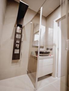 a kitchen with a glass door and a sink at Le Beach in Saint-Tropez