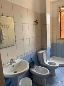 a bathroom with a toilet and a sink at Marconi Apartments in Durrës +64 photos